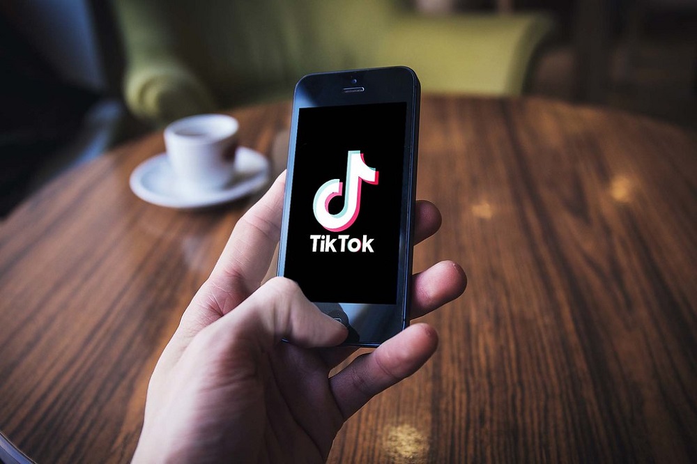 person use TikTok in iPhone